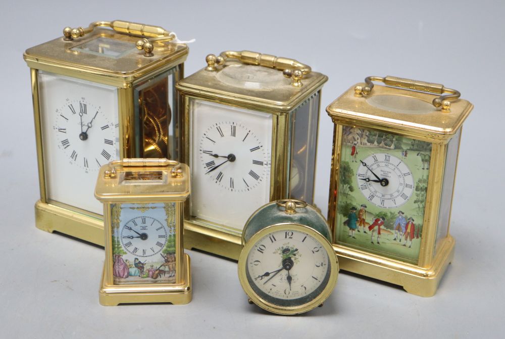 An Asprey brass cased carriage clock, another carriage clocks, two Halcyon Days carriage timepieces and an alarm clock, tallest 14cm (h